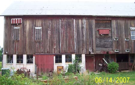 The two large bat boxes on the barn wall